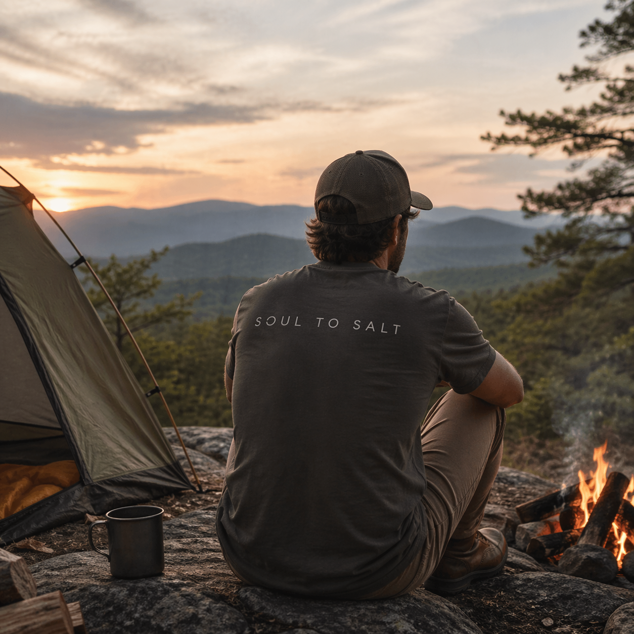 a man camping on top of mountain with tent, coffee, and fire pit